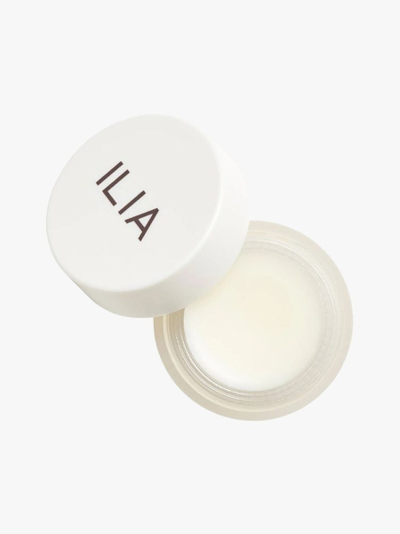Ilia Lip Wrap Overnight Treatment top view of a jar of white lip balm with white cap ajar on light gray background